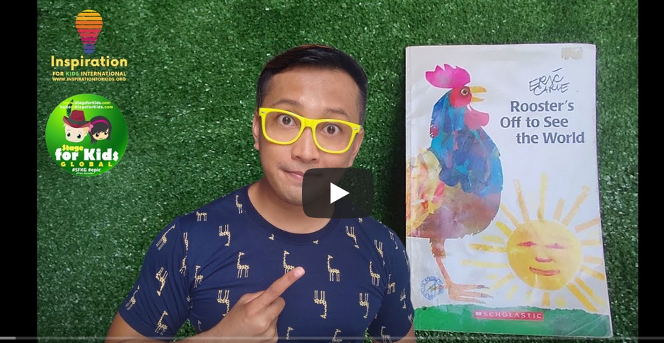 inspiration for kids teacher Emil A man with yellow glasses gestures next to a book titled "Flapdoodles Off to See the World" against a background with artificial grass.